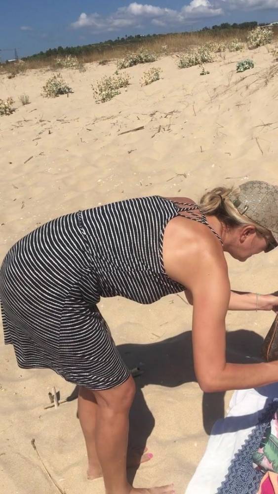 Hot milf stripping at the beach - xhamster.com