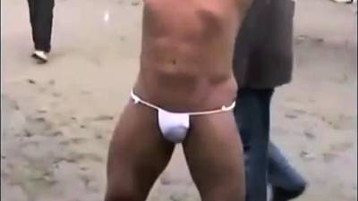 Asian bodybuilder barely covered at the beach - drtvid.com