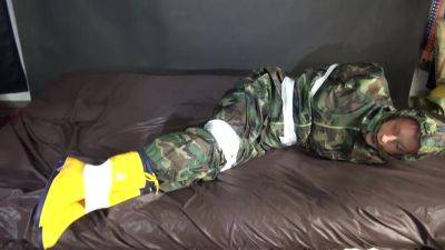 Watching Sexy Pia Being Tied And Gagged With Tape On A Bed Wearing A Sexy Camouflage Shiny Nylon Rainpants And A Rainjacket As Well As Yellow Rubber Boots (Video) - hotmovs.com