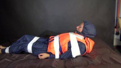 Sexy Sandra Being Tied And Gagged With Tape On A Bed Wearing Blue Rainwear And A Lifevest (Video) - hotmovs.com