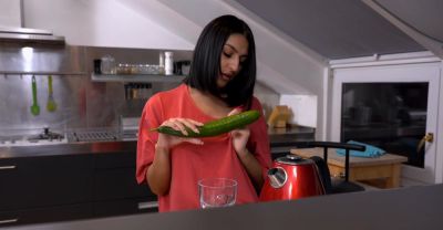 A cute girl peels a cucumber for her older man in a sensual scene. - alphaporno.com