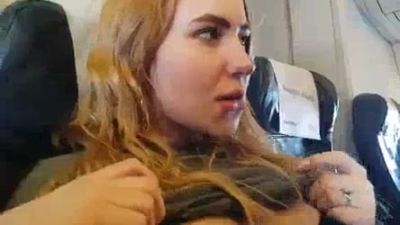 Blonde gives a discreet handjob during a flight in plain sight - yesvids.com
