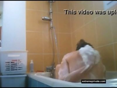 Hidden camera captures a nude figure bathing and leaning over the tub - yesvids.com