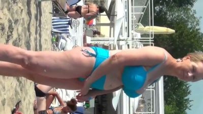 Curvy blonde embraces full nudity on a sunlit beach with voyeuristic flair - yesvids.com
