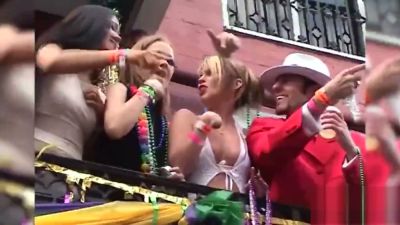 Young adults flash bare backsides amid Mardi Gras bead chaos on a dim balcony - yesvids.com