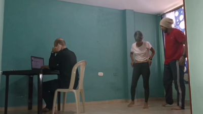Mature Spanish-speaking men share a quiet moment in a colorful room with teal walls - yesvids.com